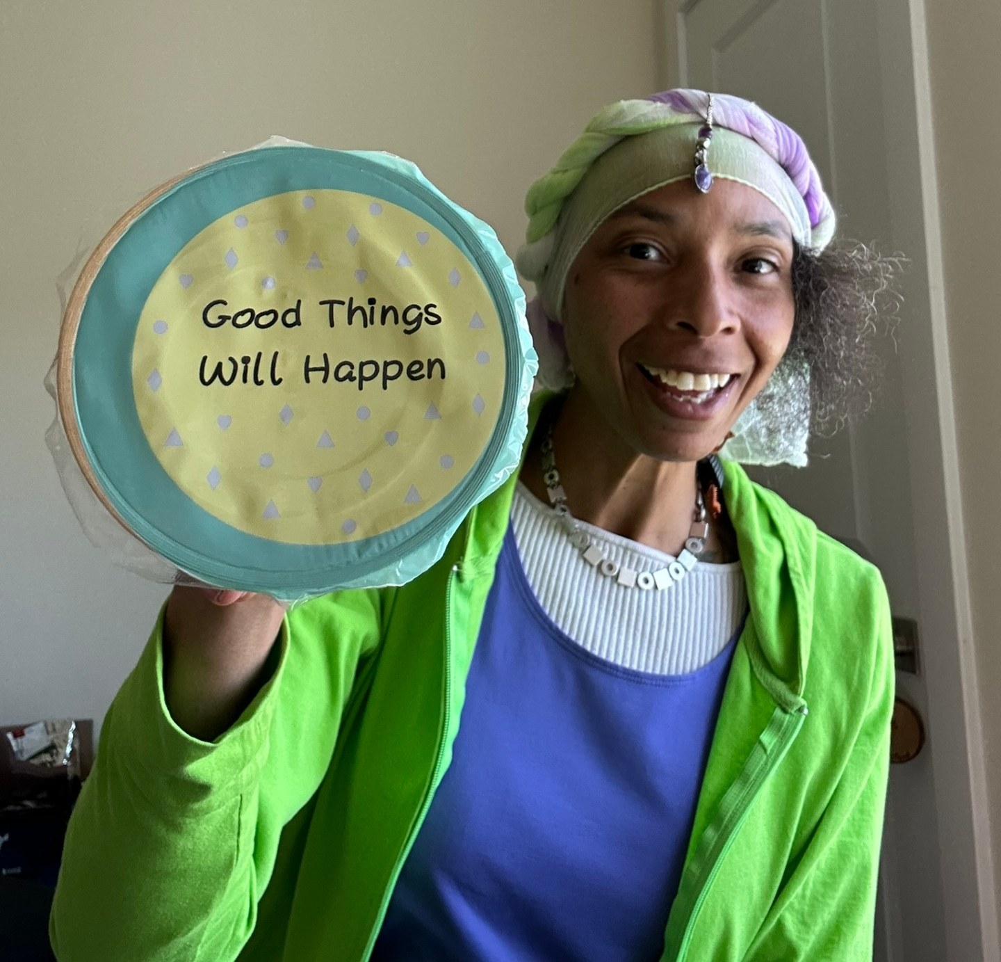The Messenger (apØstLaNeedA) holding a 'Good Things Will Happen' sign