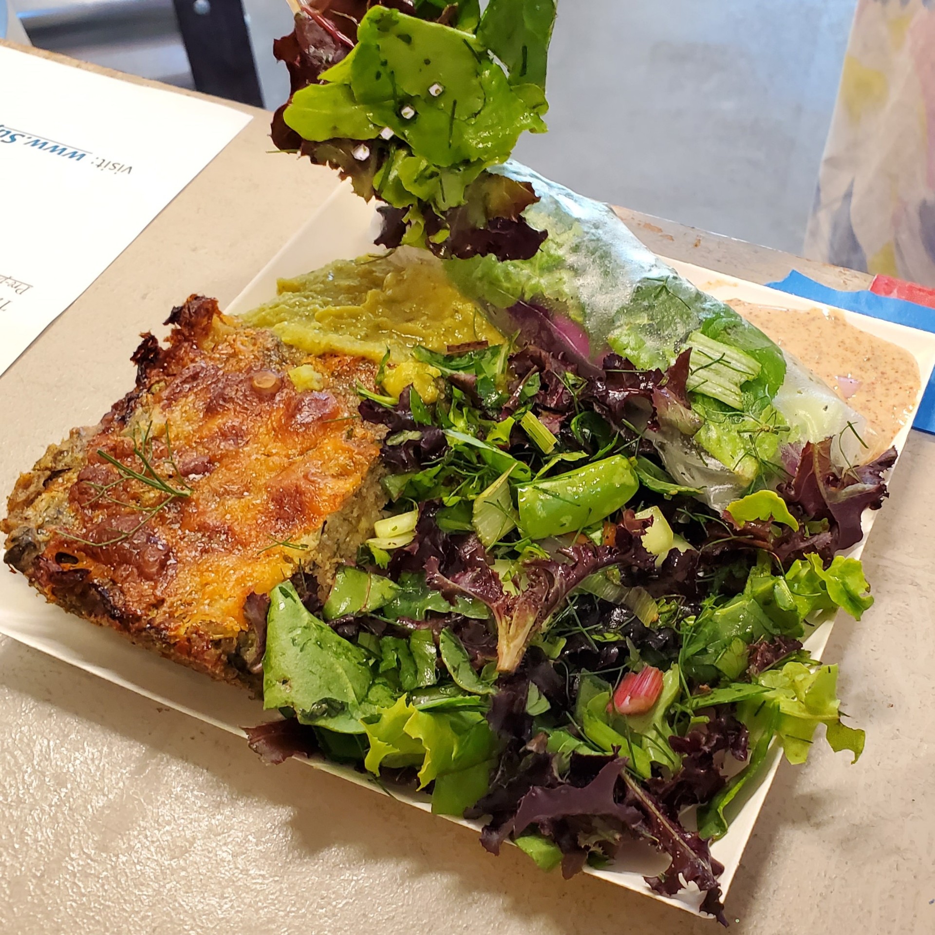 Vibrant plant-based plate with salad and savory bake